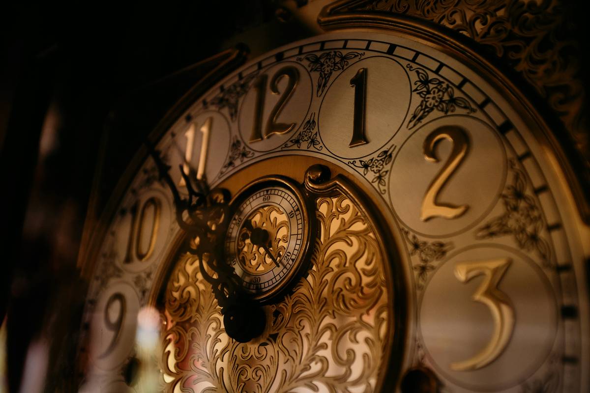 Close-up of how to fix mantel clocks by applying clock oil to pivot points