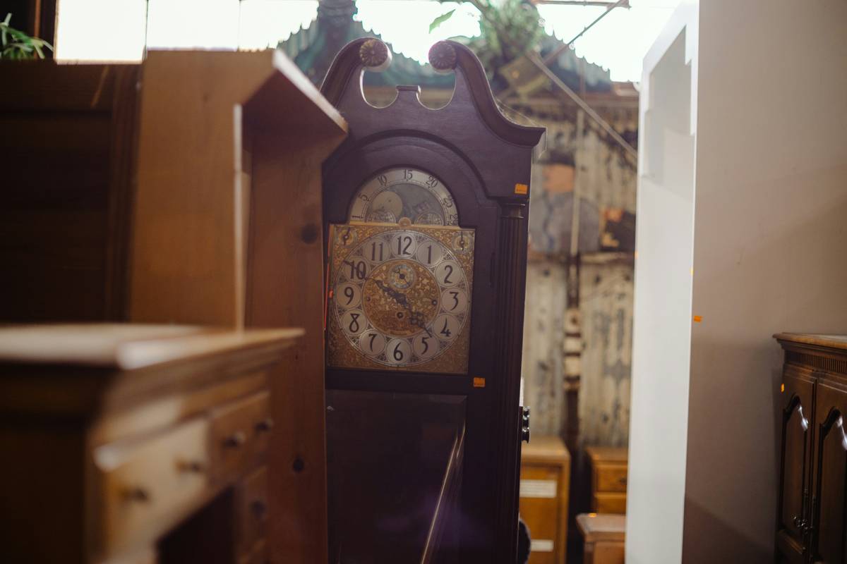 Custom printed mantel clocks displayed on a rustic wooden mantel with family photos and greenery